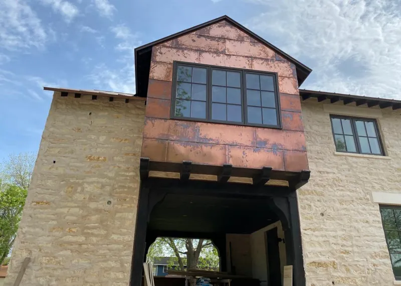 Copper metal panel facade on a stone building for Skylight Installation in Sinton